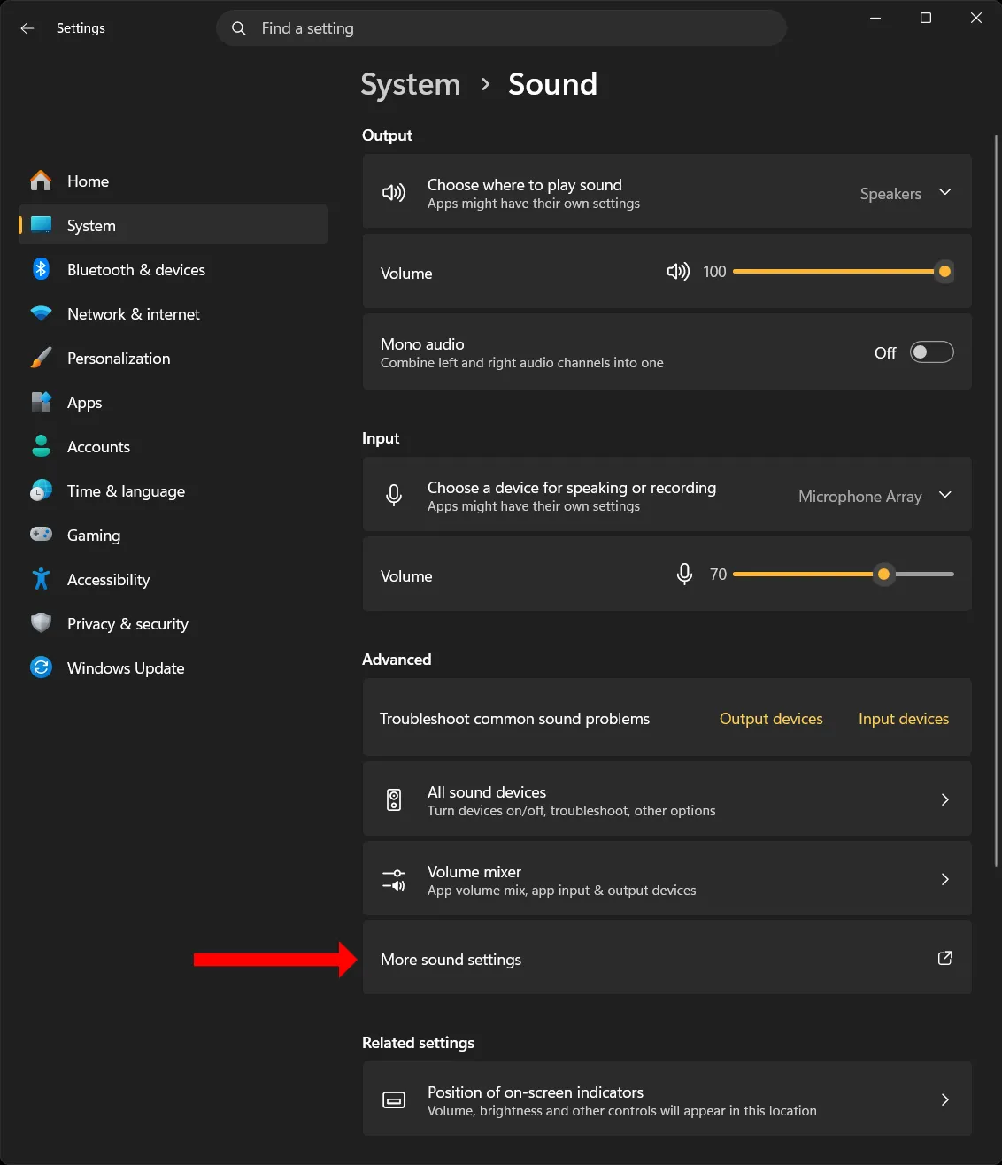 Windows 11 Settings on the Sound page under System, scrolled to the Advanced section, with a red arrow pointing at the last entry, More sound settings